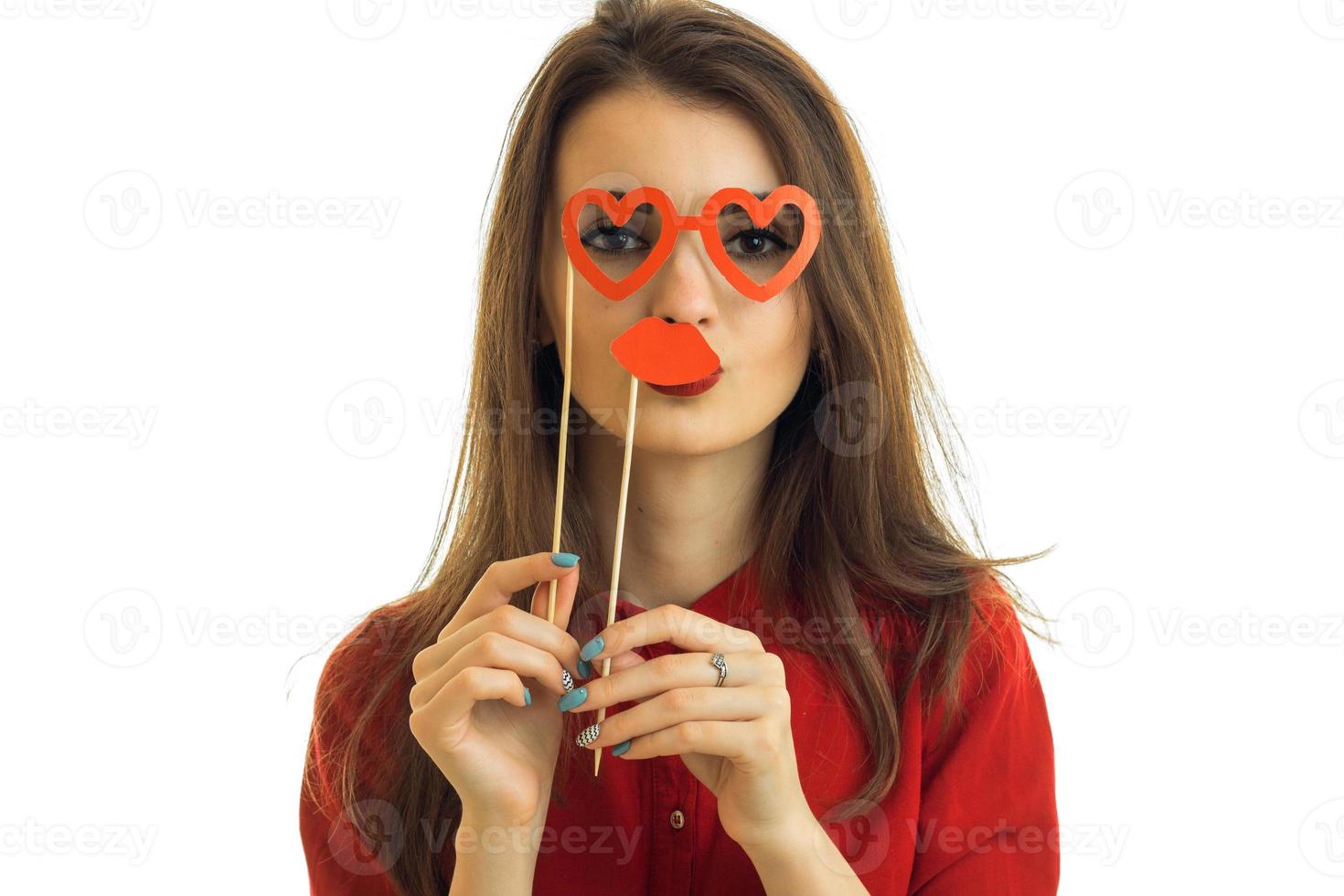 Portrait of a young charming girl who keeps near the face paper Dummies close-up photo