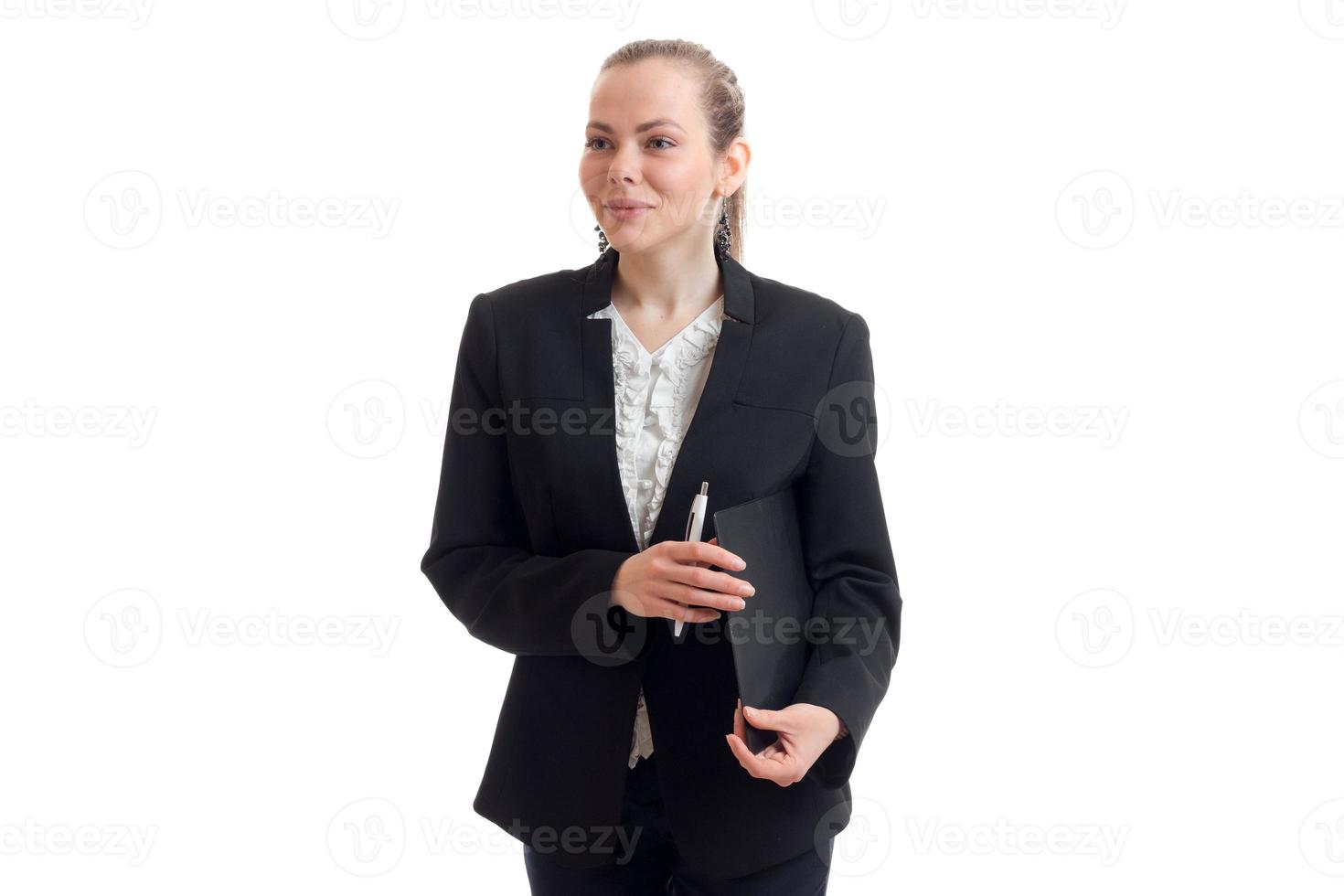 smiling young business woman stands upright in the jacket and holding a folder photo