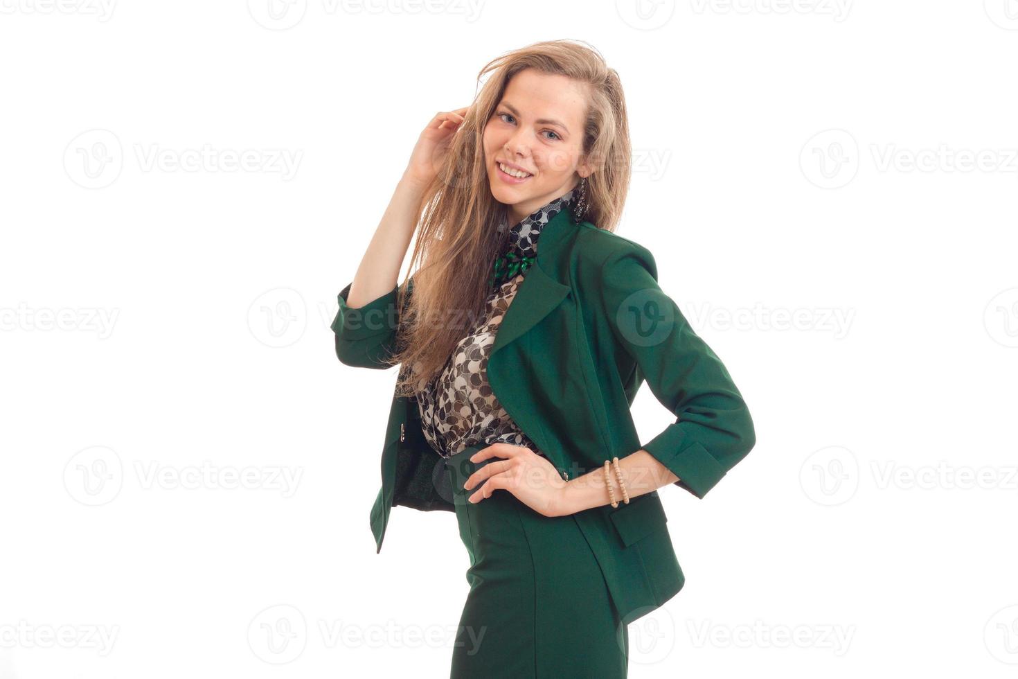 beautiful young girl with blond hair smiling and posing for the camera in a green suit photo
