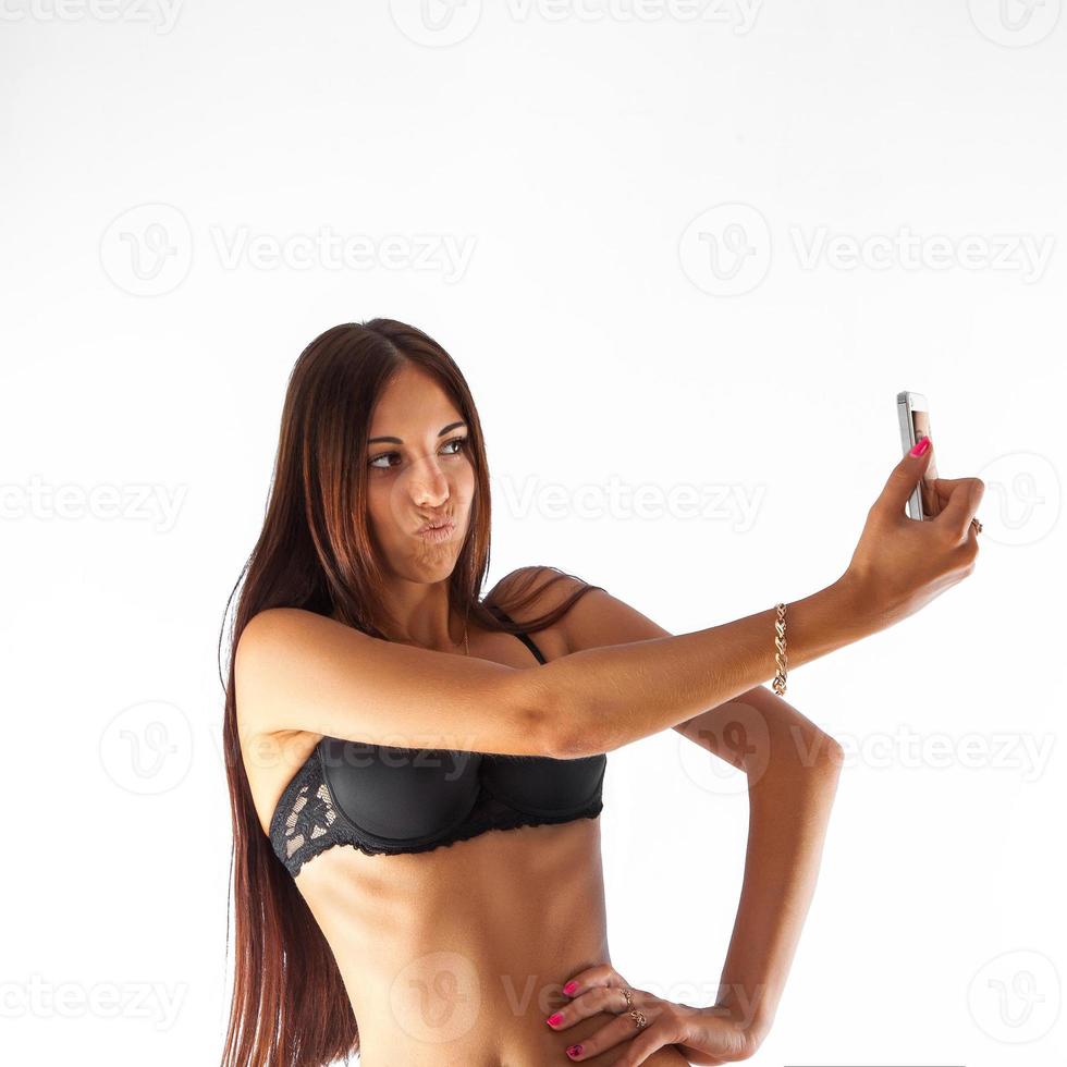 Cute girl in bra making fun selfie photo