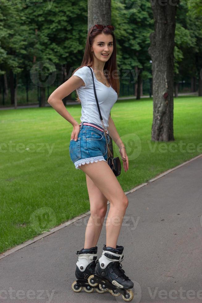 cute slim girl skating on roller photo