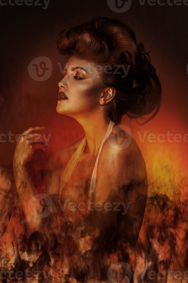 Sexual adult brunette in bandage with fire photo