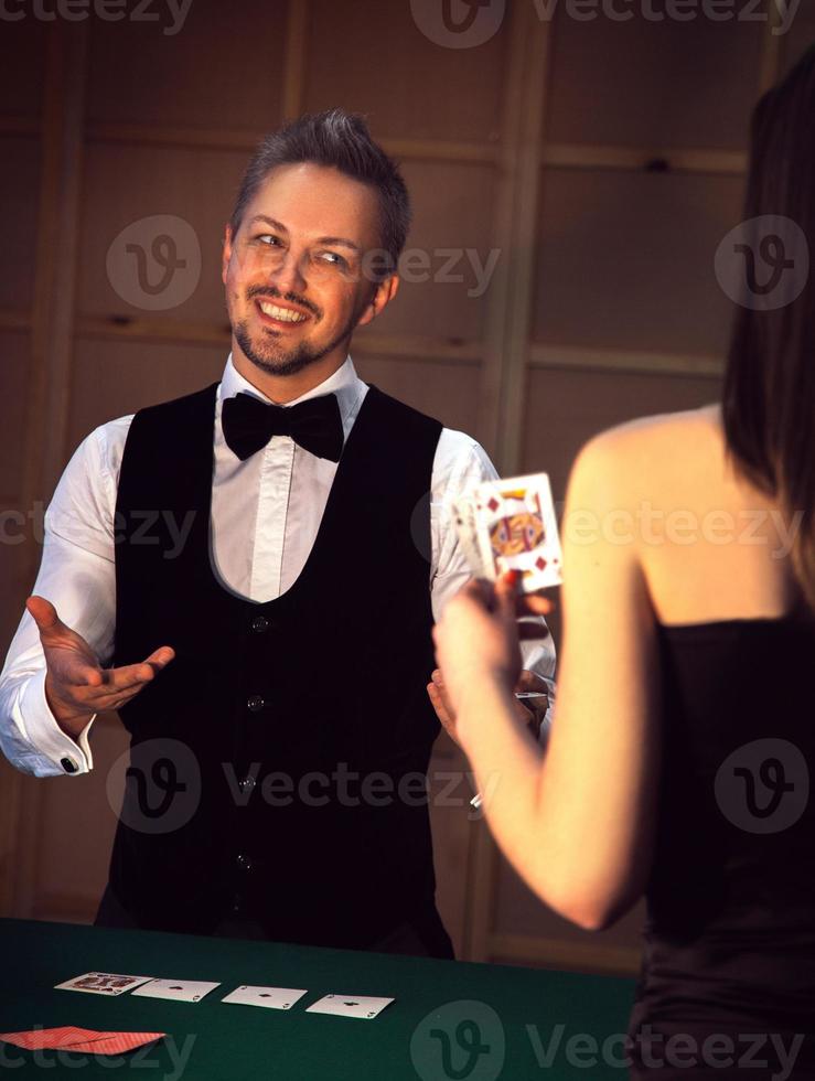 elegant dealer smiling girls playing poker photo