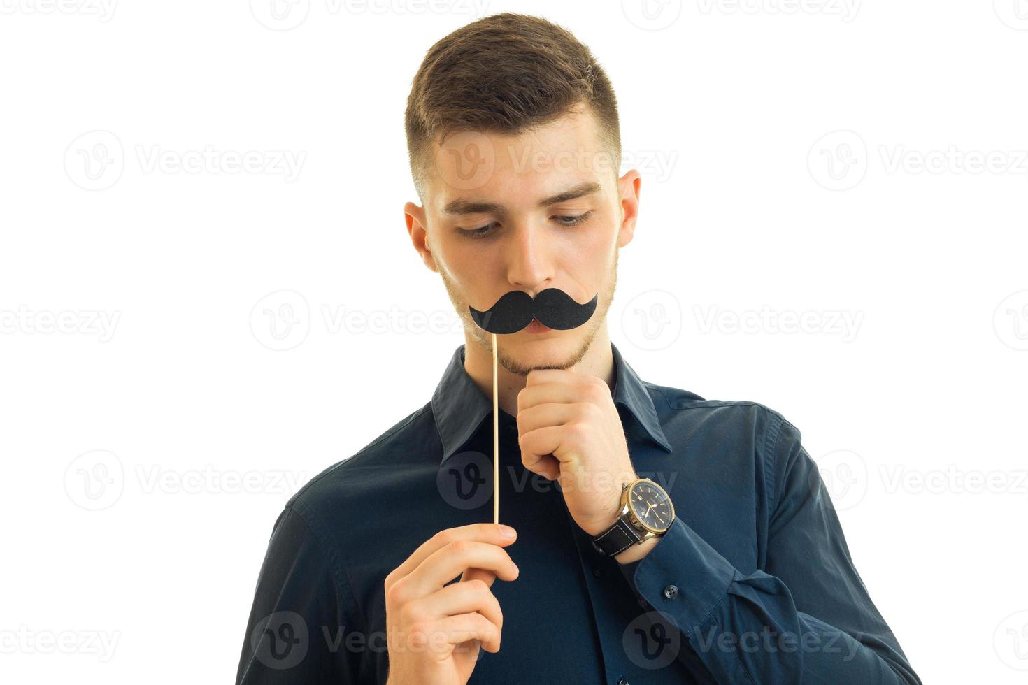 otherwise Winsome young guy keeps near the face, paper mustache photo