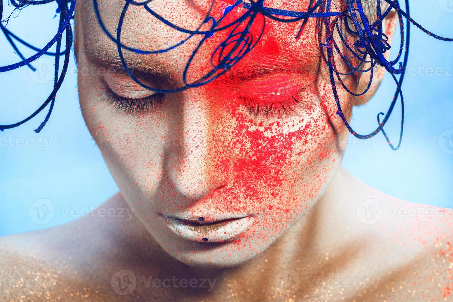 horizontal portrait of sexy woman with neon powder on face in studio photo