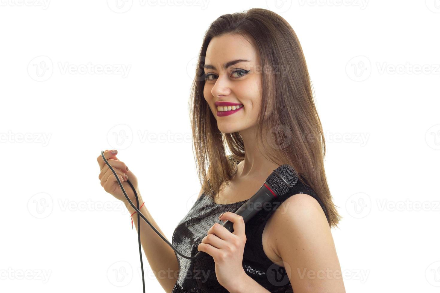 Pretty young girl smiles and sings karaoke and smiles photo