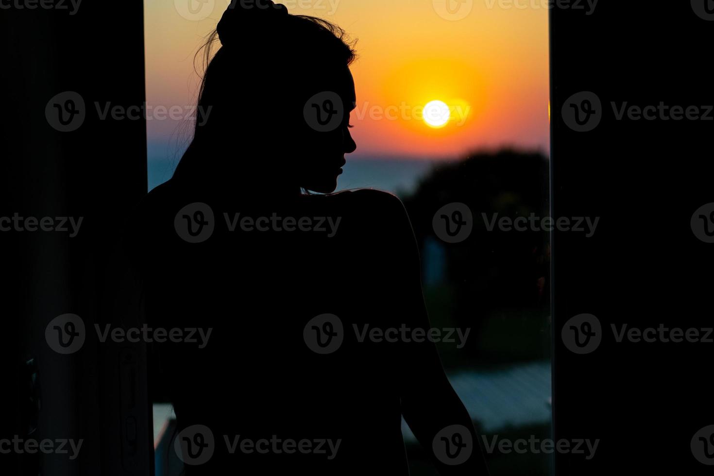 Silhouette of seexy girl in sunset photo