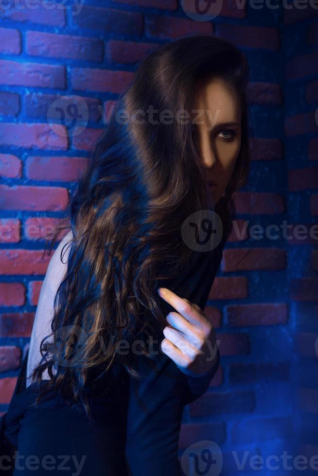 stylish girl stand near brick wall photo