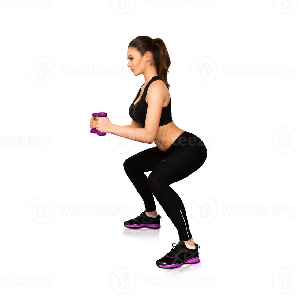 Attractive slim woman concentrated on fitness photo