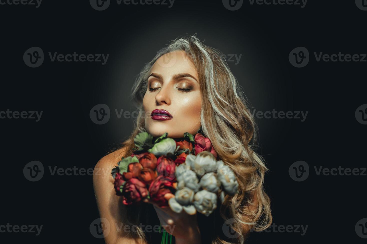 Portrait of attractive grey hair woman with flowers photo