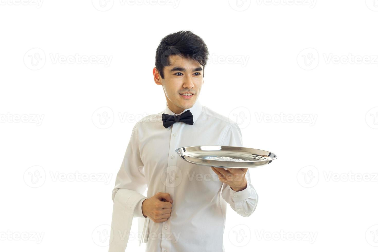 a young waiter in chic shirt looks forward and hands in hand tray photo