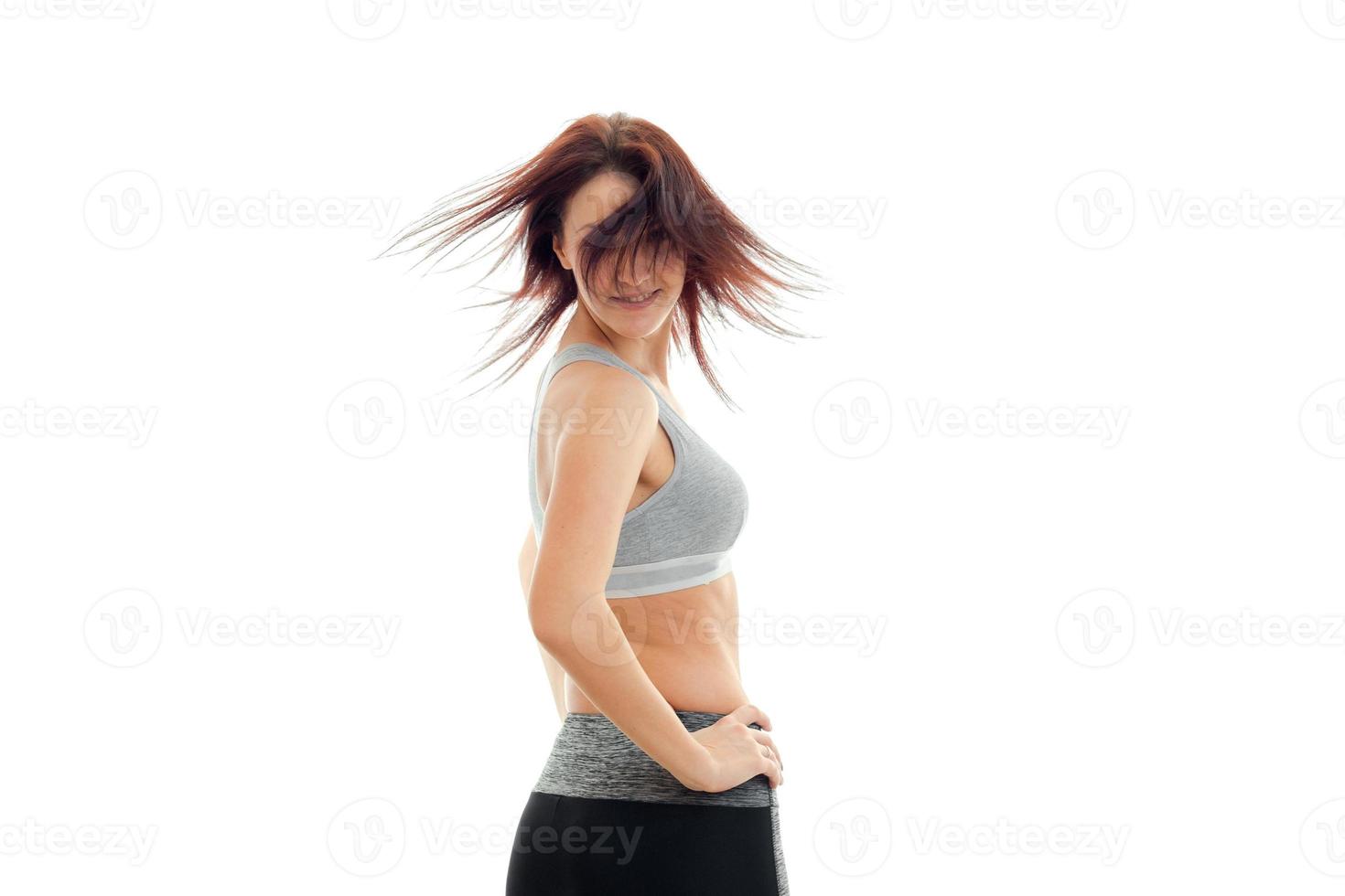 young skinny girl turns your head forward and her hair fly through the air photo