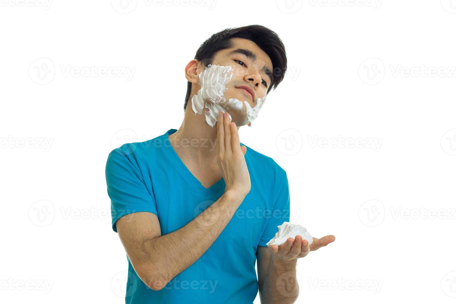 young guy shaving his face with foam photo