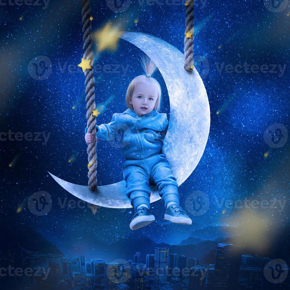 Cute little girl sits on the moon above the city and looks on the stars photo