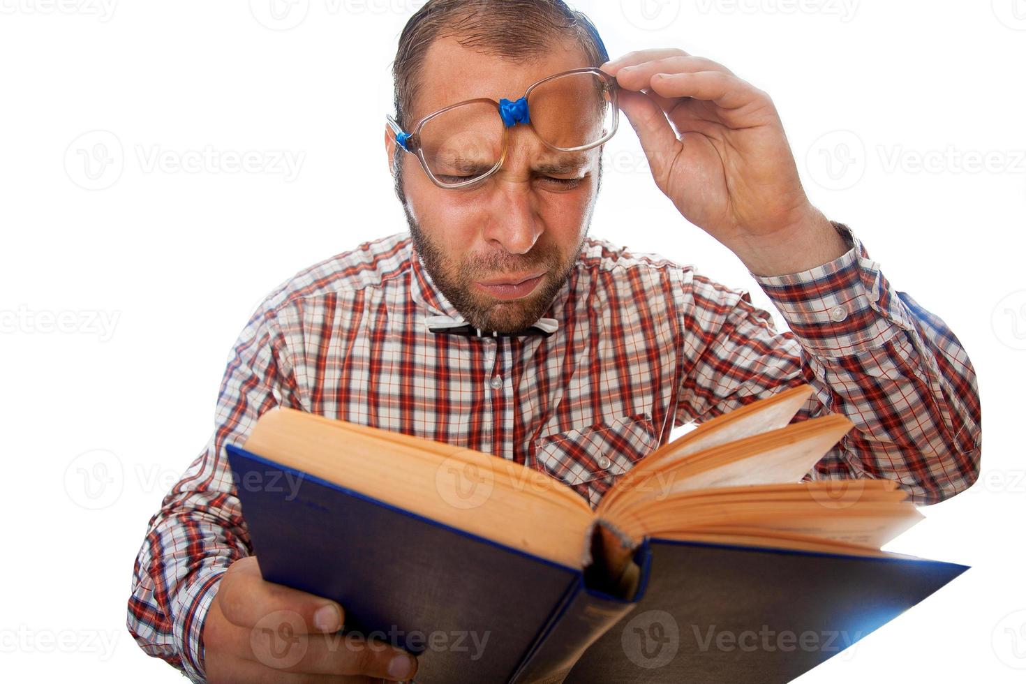 Horizontal photo of geek with poor eyesight reading a book