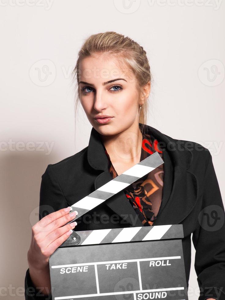 portrait of pretty girl with film slate photo