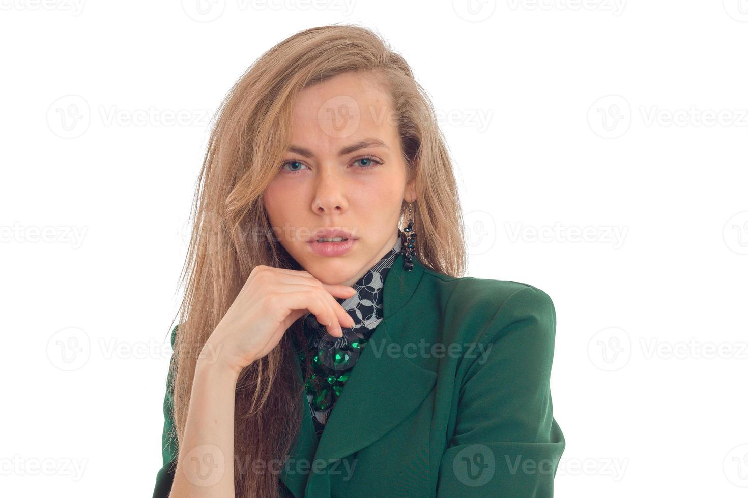 Attractive blonde business lady in green uniform looking at the camera with tricky glance photo