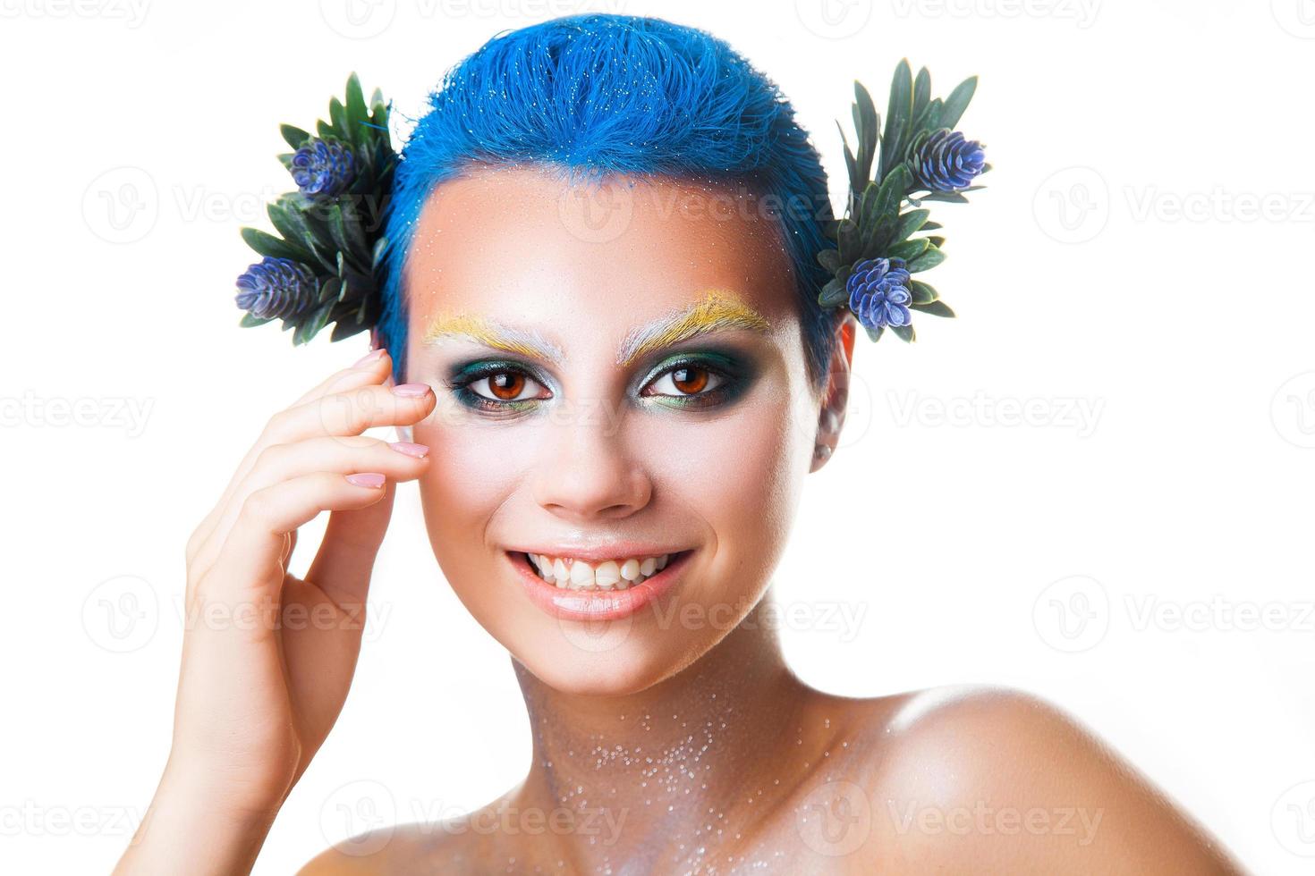 Elegant young girl with multicolor makeup smiling on camera photo
