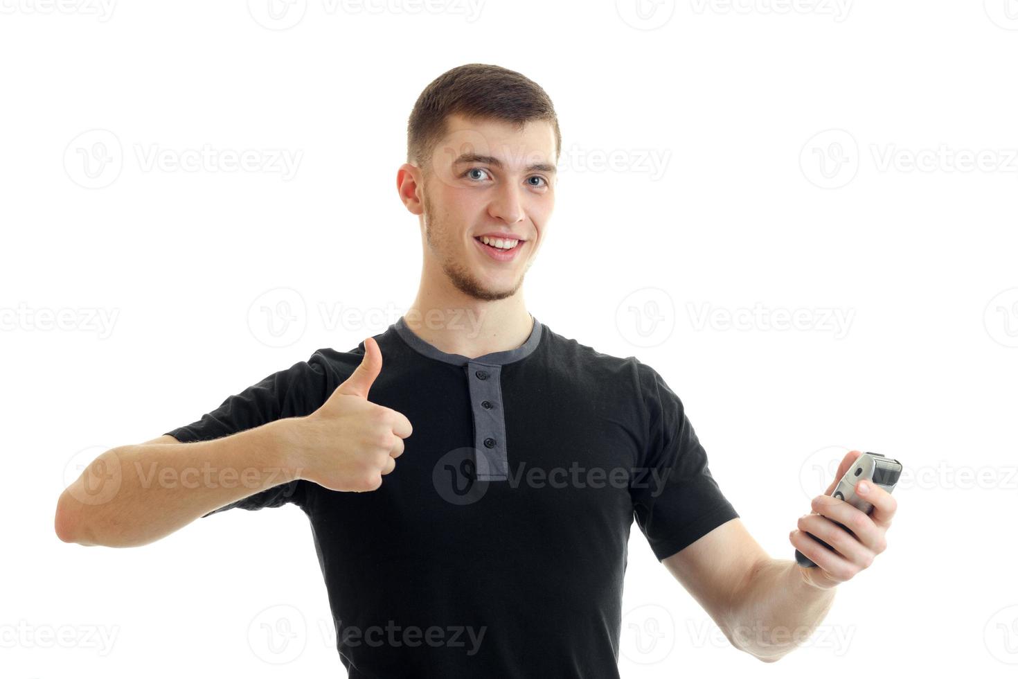Cheerful man with trimmer in one hand showing thumbs up with another photo