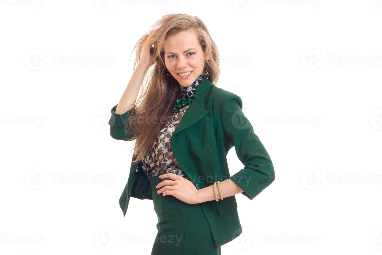 Beautiful blonde business woman smiling on camera in green uniform photo