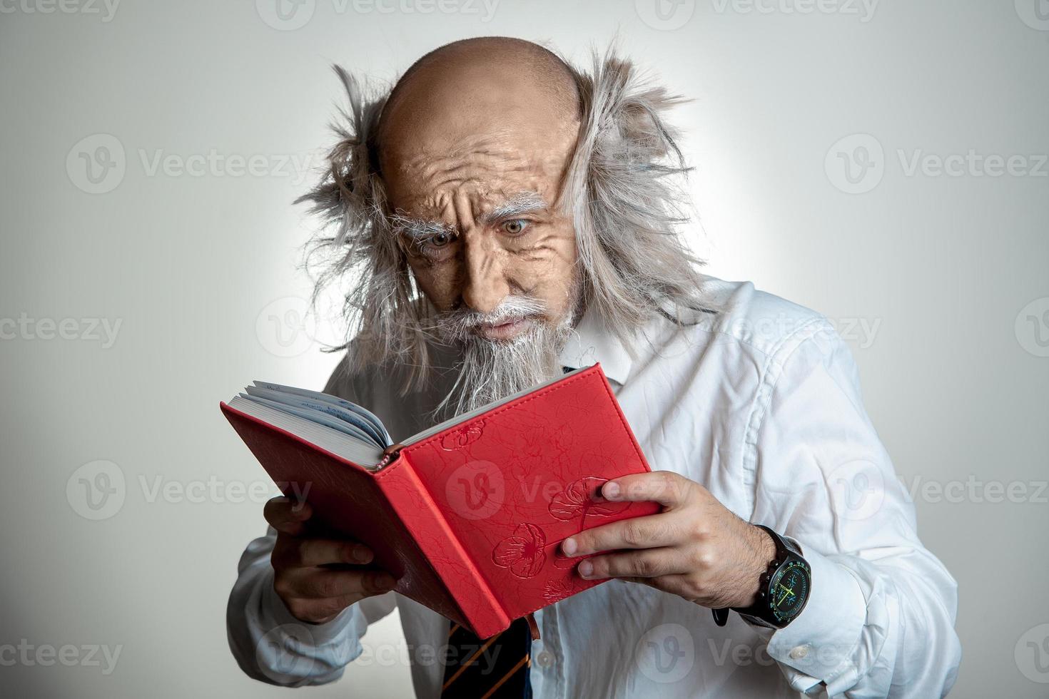 old man trying to read a book photo