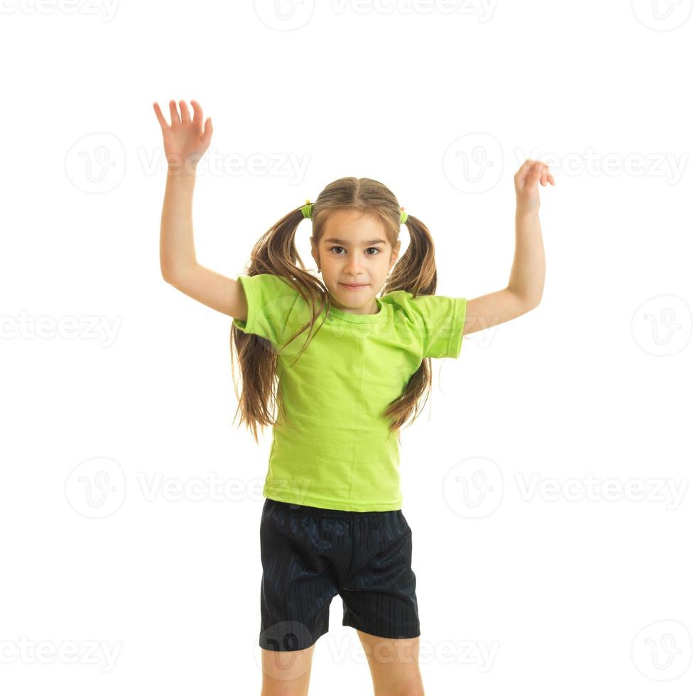 Square portrait of funny little girl with hands up in the air photo