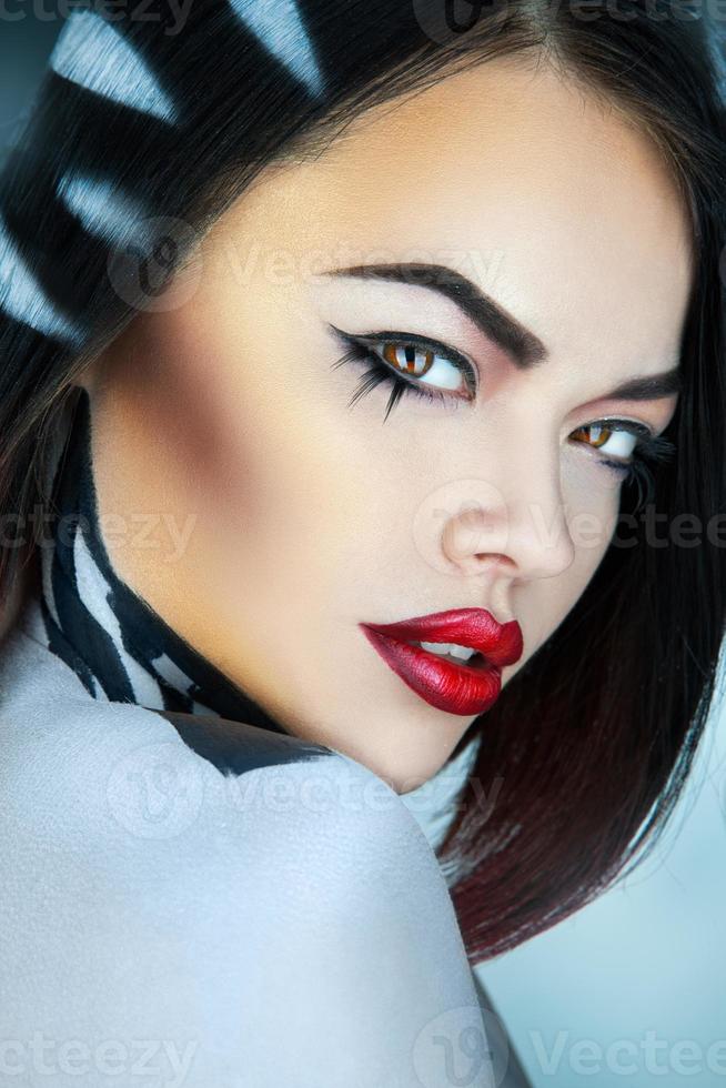 Portrait of fashion model in studio with stripes on hair in studio photo
