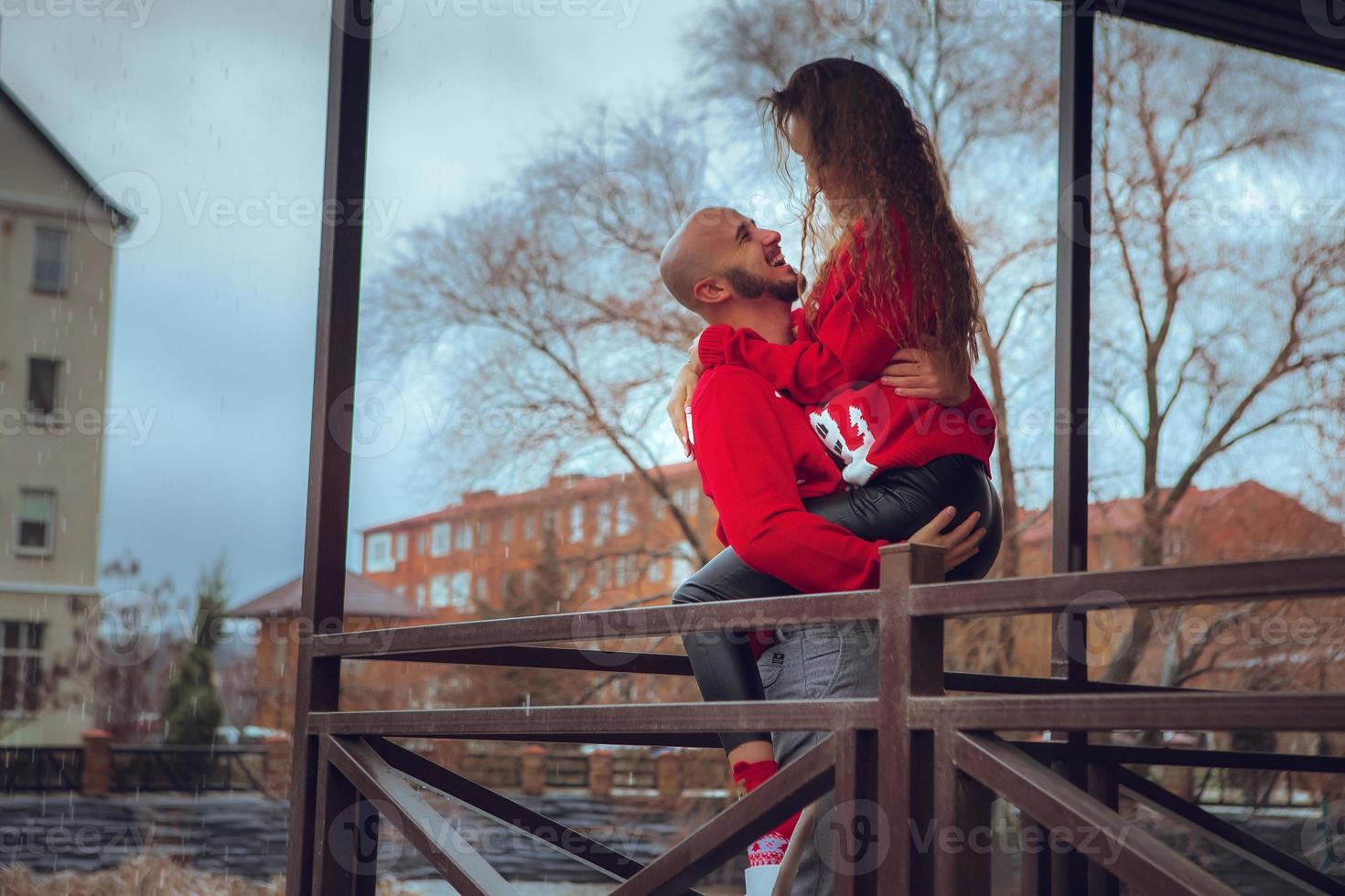 beautiful couple hugs on a balcony winter time. Christmas Mood photo