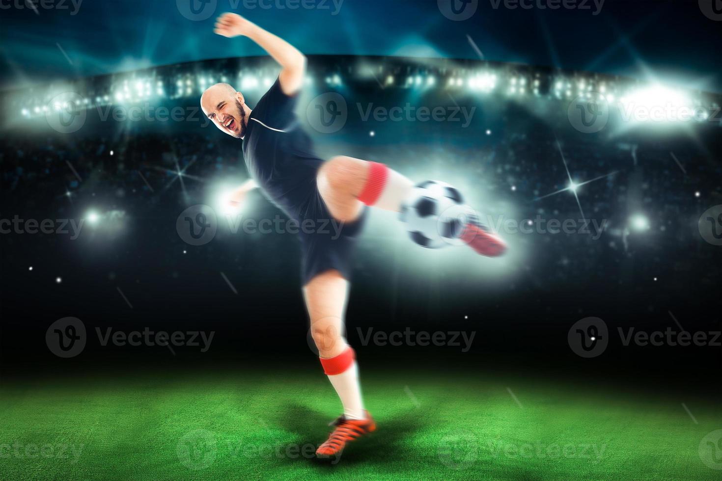 Professional soccer player in the game shoot the ball photo