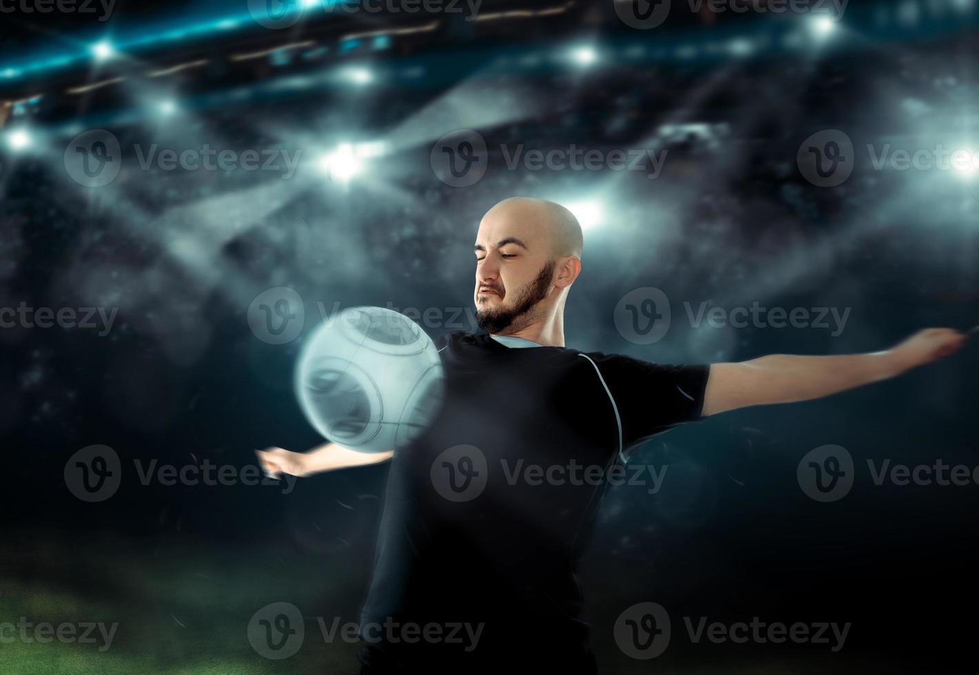 Soccer player receives the ball on his chest in football game photo