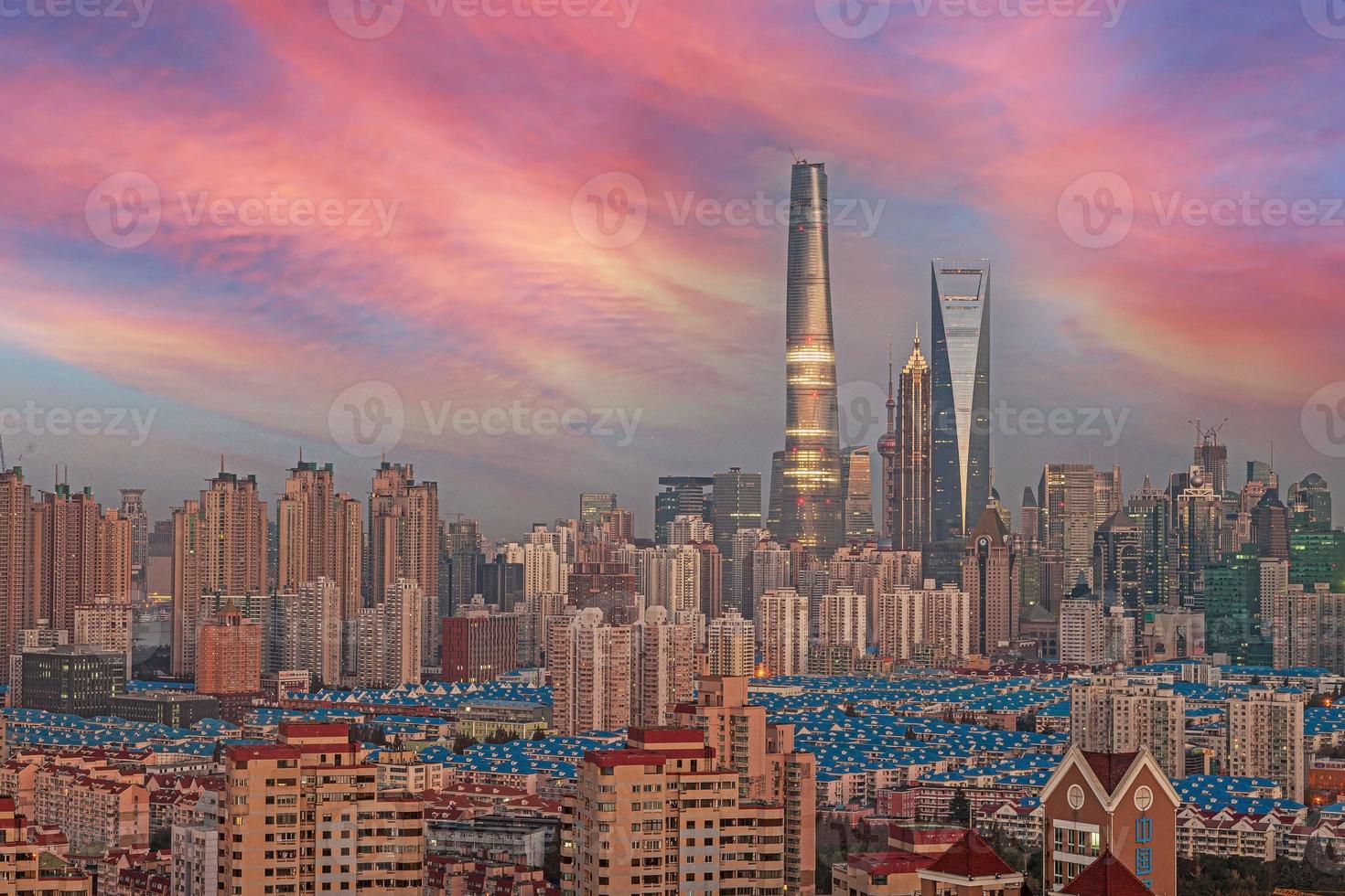 View of the skyline of Shanghai's Pudong business district against an impressive evening sky photo