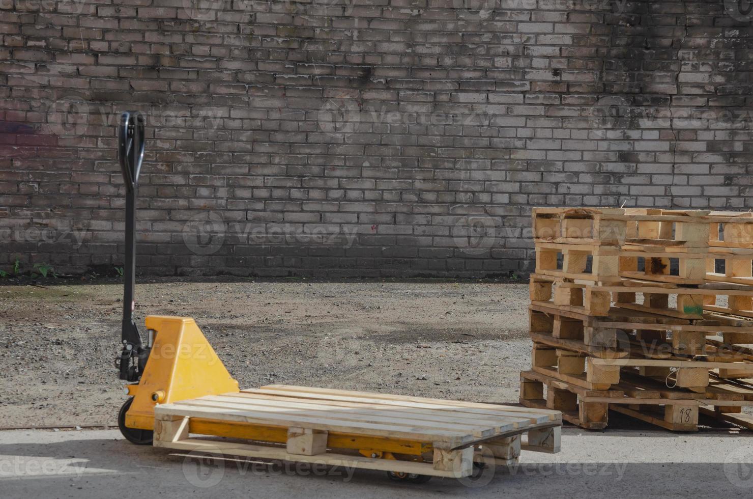 hydraulic trolley with wooden pallet for loading. Pallet jack photo