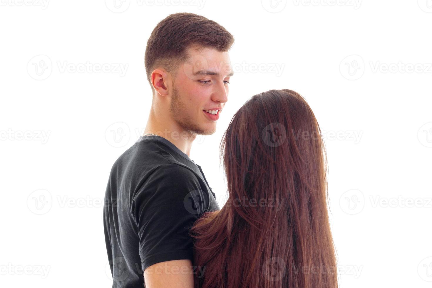 girl with long hair cute smiling stands opposite guy close-up photo