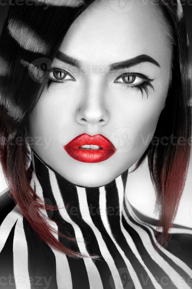 desaturated Fashion model with stripes on body and hair looking at camera in studio photo