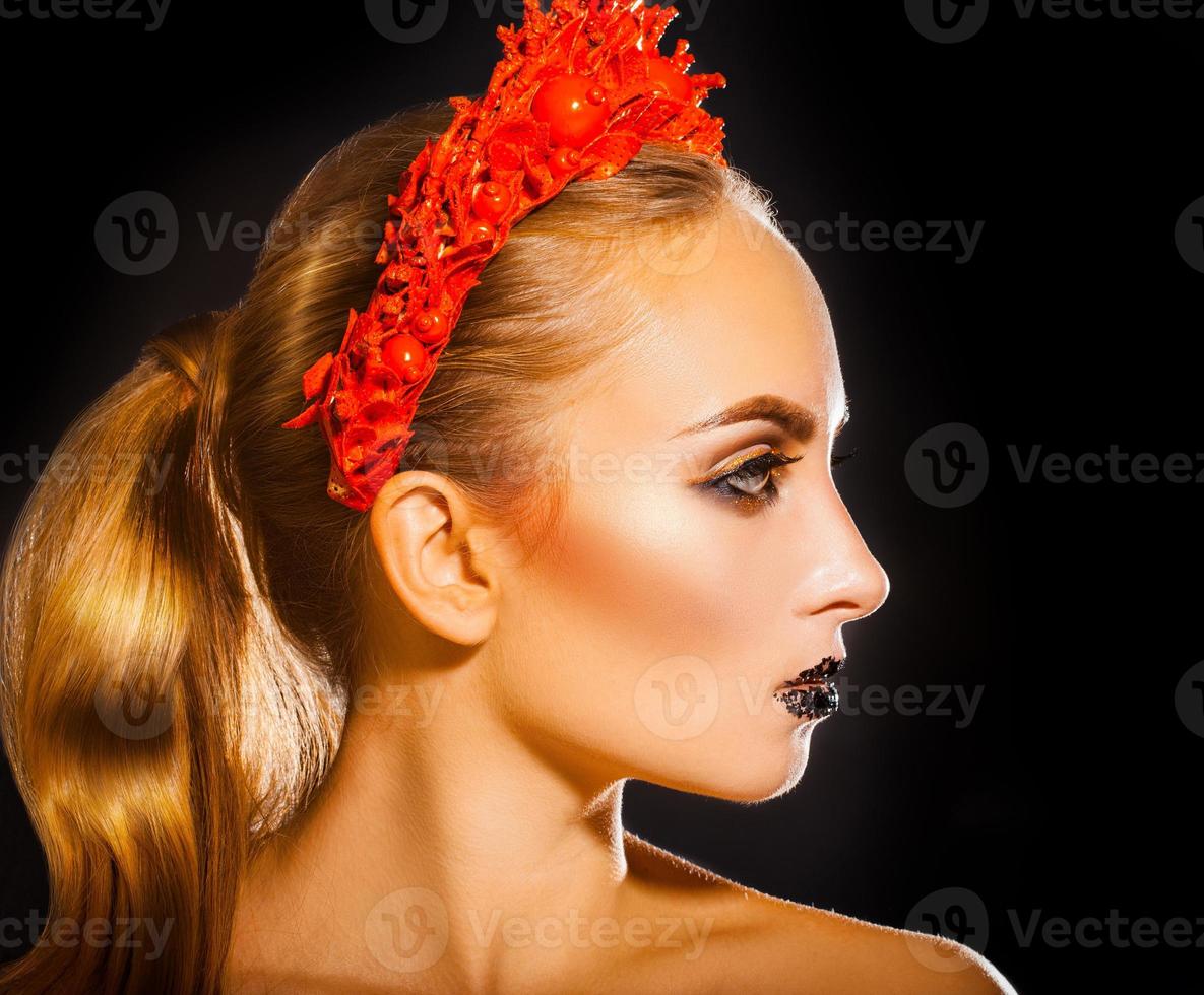 Beauty woman with red wreath and makeup on black background photo