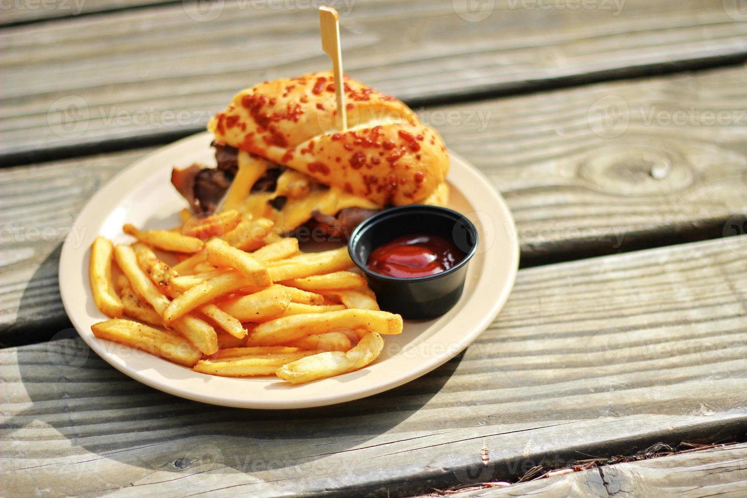 THE PRIME RIB DIPPER Food from applebee's restaurant served on a brown wooden table. sunny morning photo