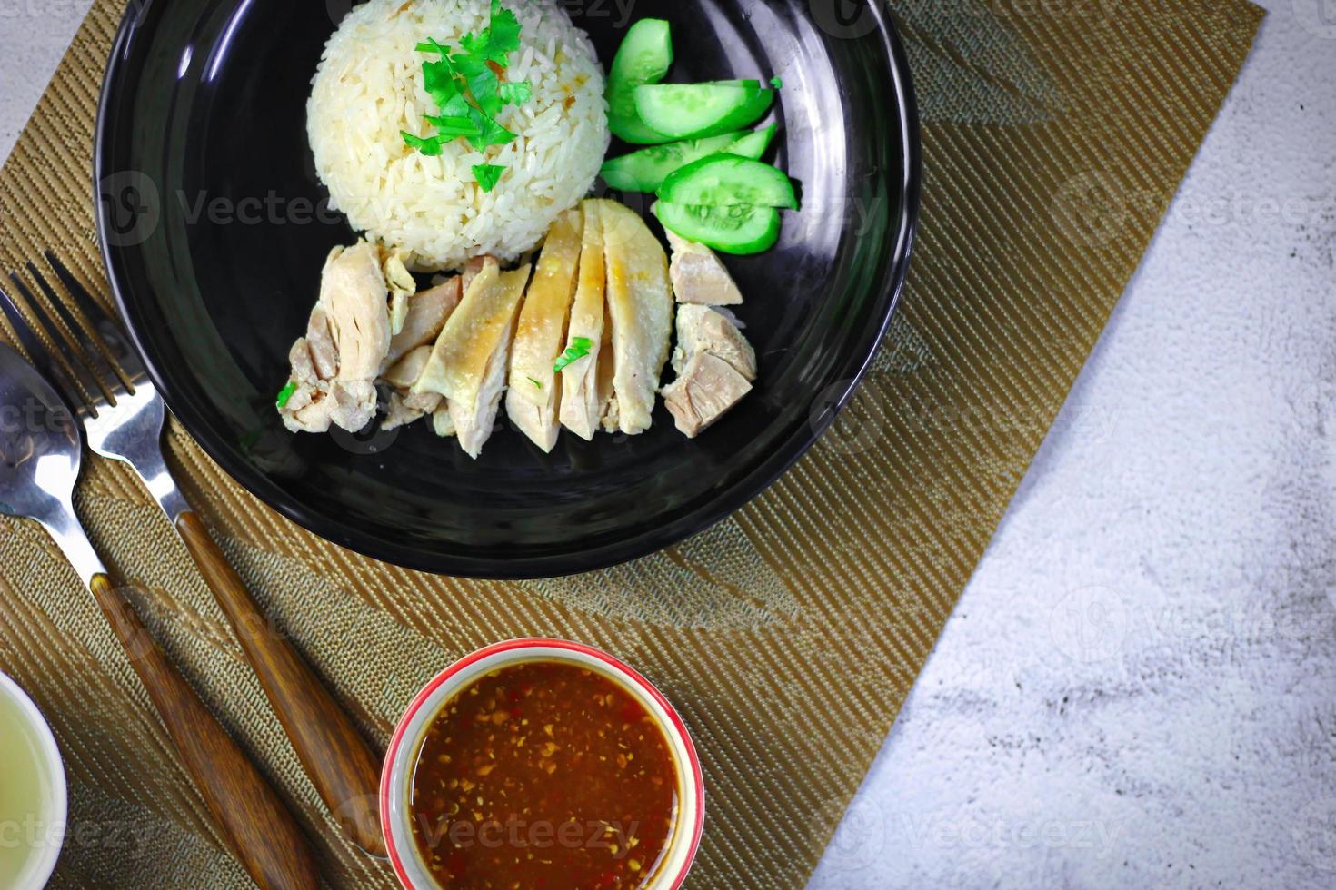 Hainanese chicken rice with soup or steamed chicken and sauces. photo