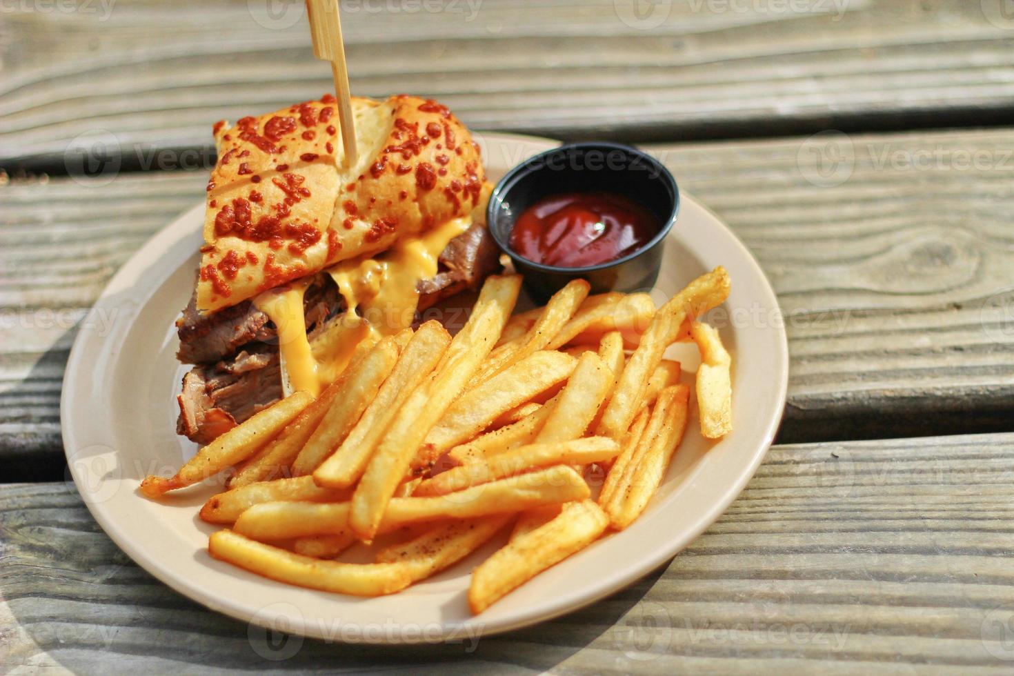 THE PRIME RIB DIPPER Food from applebee's restaurant served on a brown wooden table. sunny morning photo