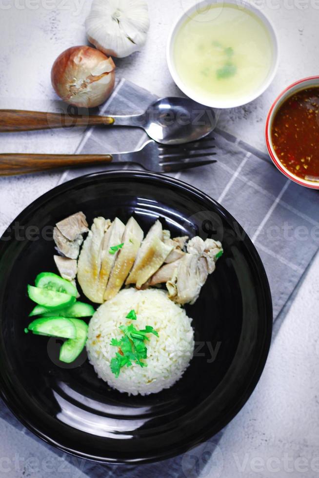 Hainanese chicken rice with soup or steamed chicken and sauces. photo