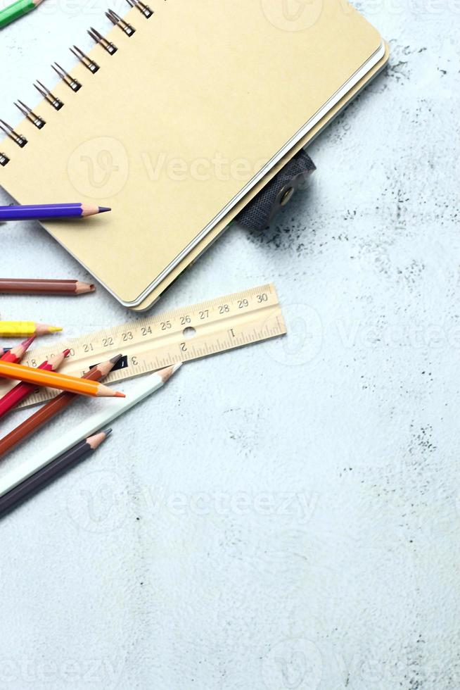 Wooden crayons scattered on the table, wooden rulers and notebooks with the festival back to the semester, students go to school, art lessons. photo