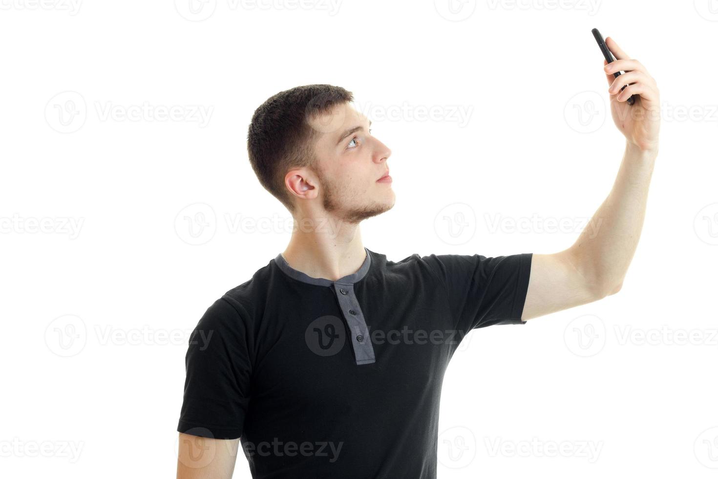 handsome young man makes selfie in studio photo