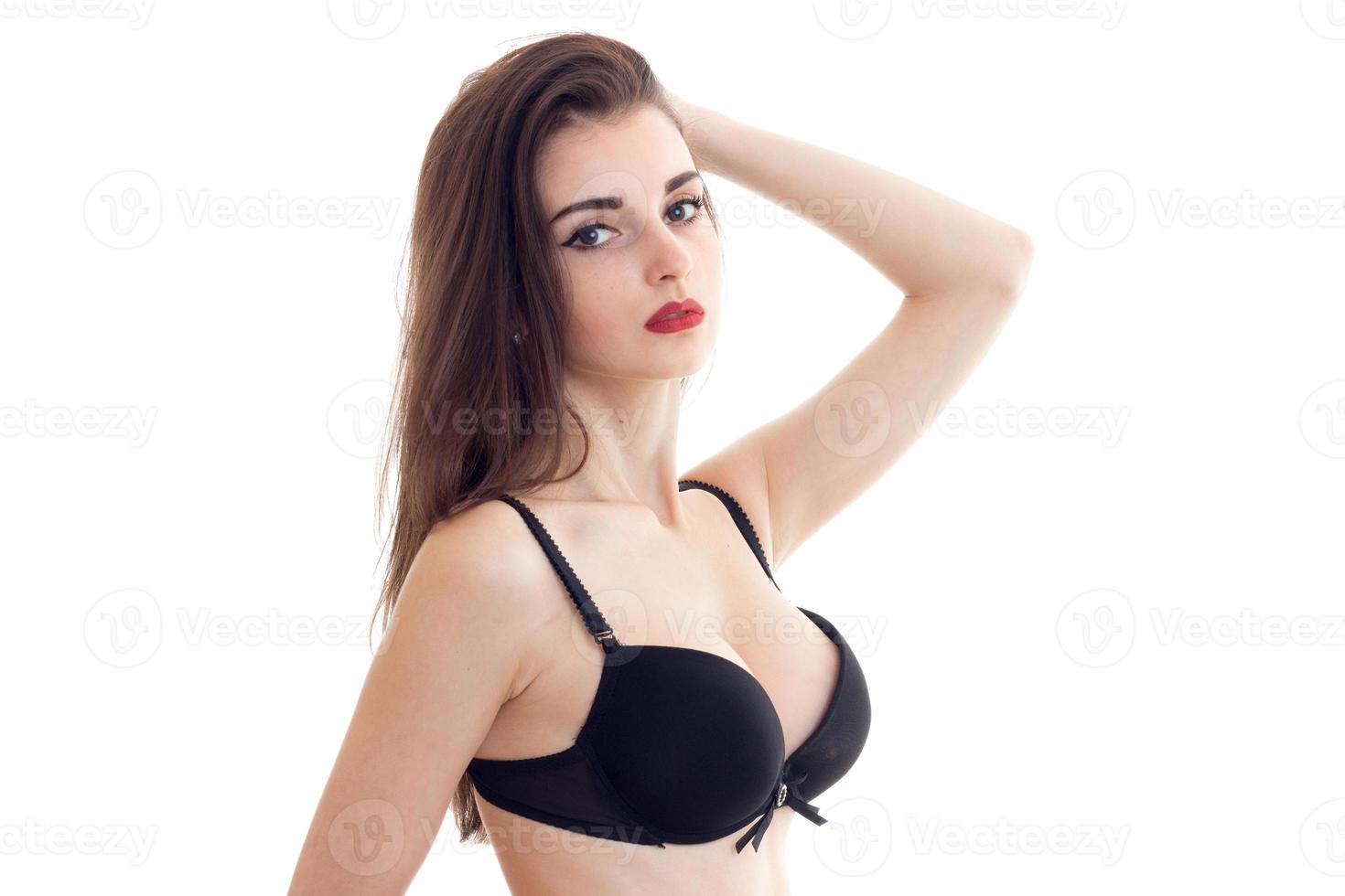 woman with red lips with big natural boobs in black bra looks at camera photo
