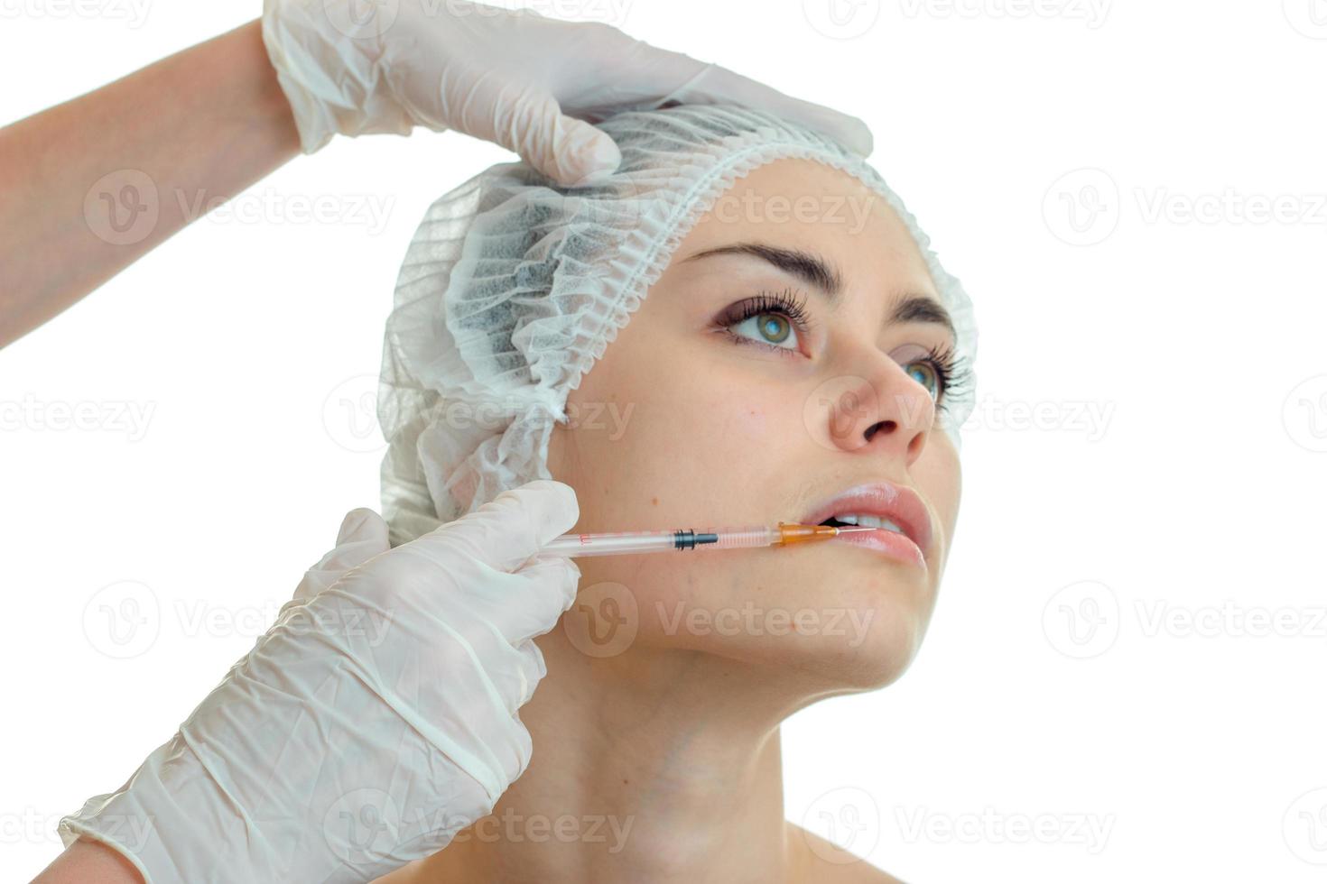 close-up portrait of a young girl with a clean skin in a special cap for hair in the Office of a doctor photo