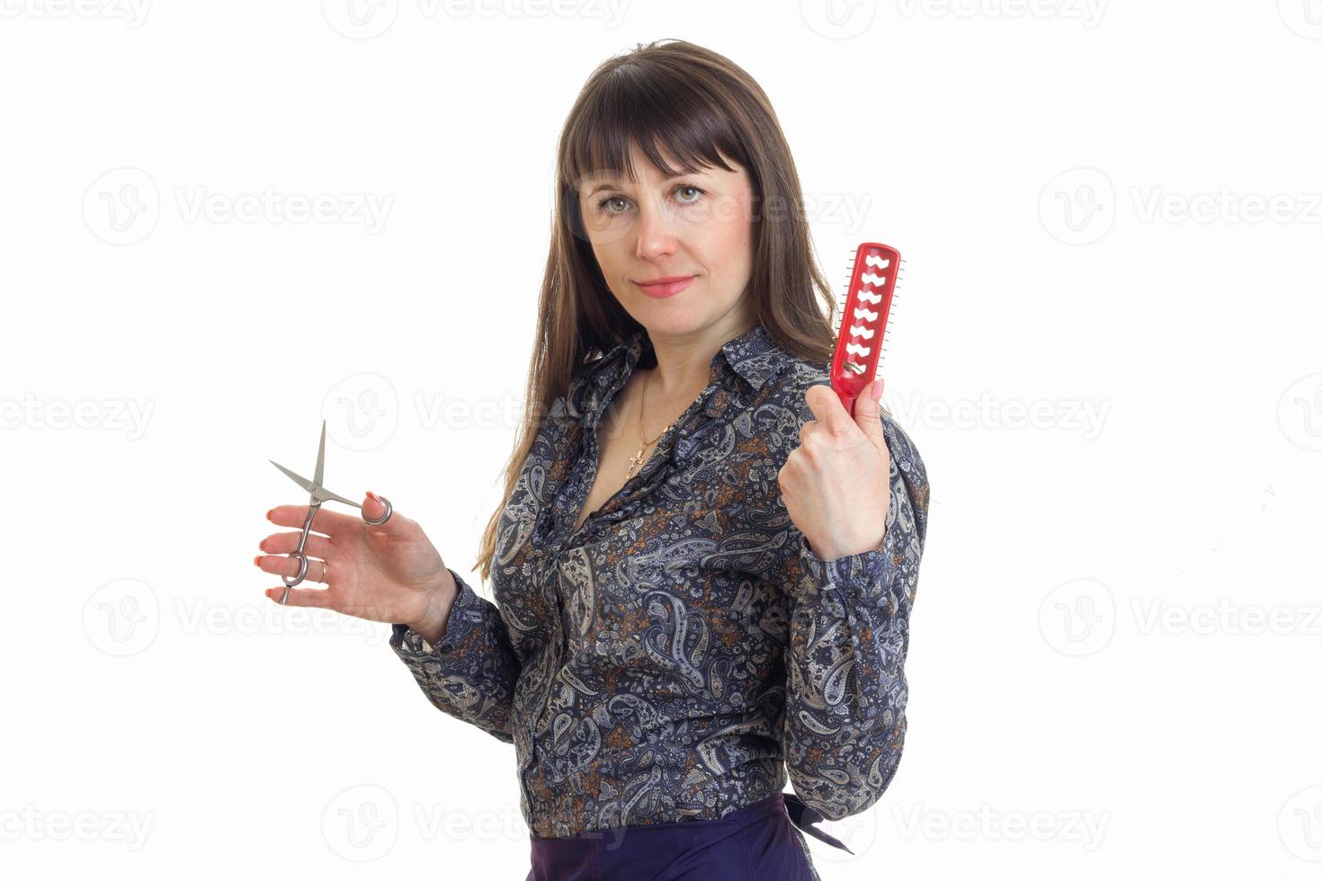 woman hairdresser with a comb and scissors in hands looking at the camera photo