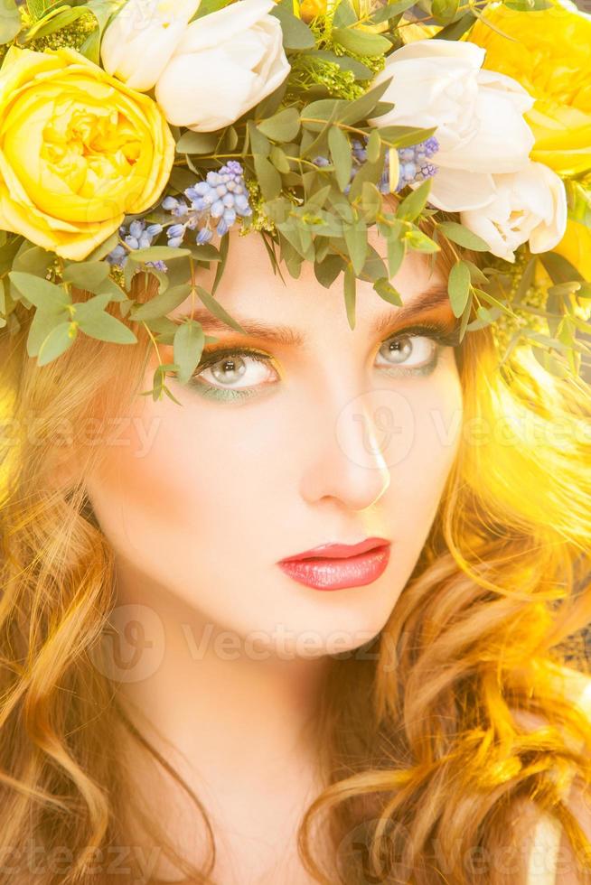 Beautiful woman with wreath on hair looking at camera photo