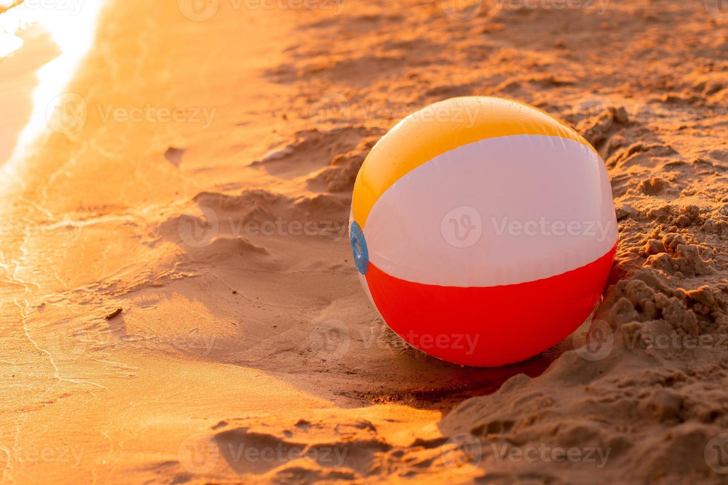 beach ball on the seashore at sunset photo