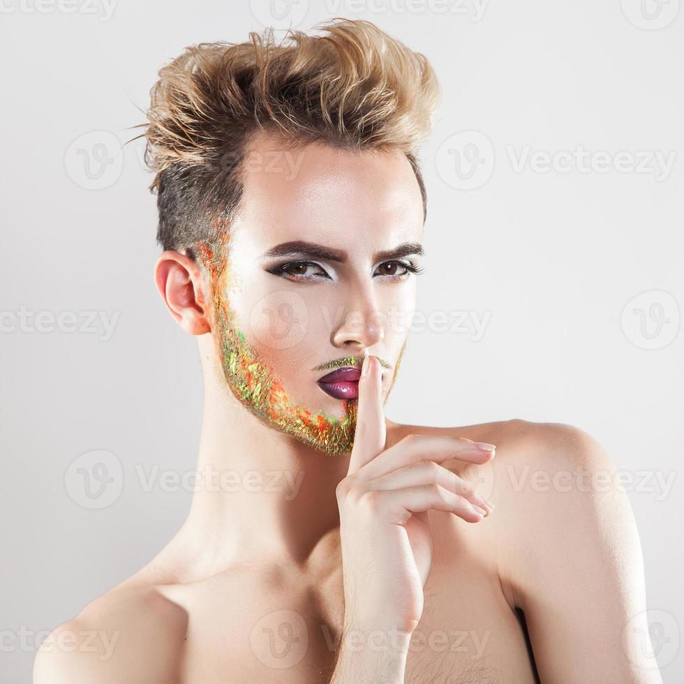 Young sexy man with multicolor beard looking at camera photo