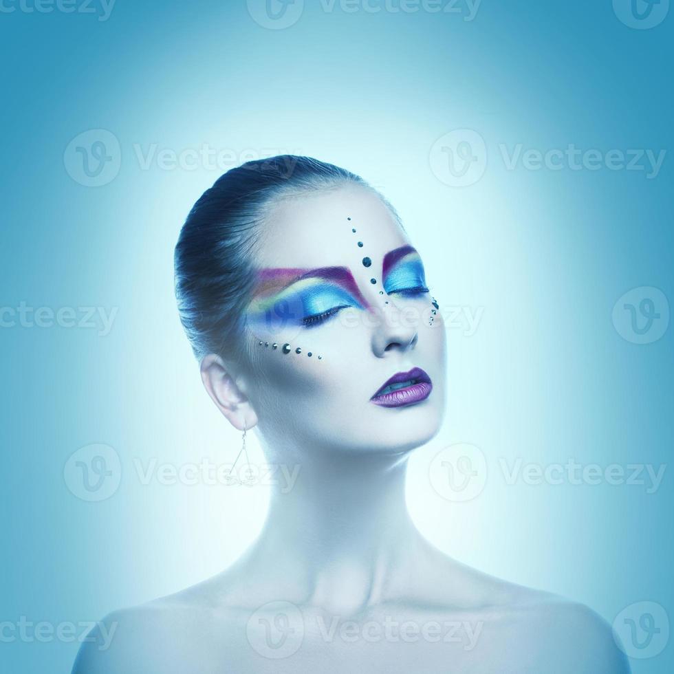 Square cold tones portrait of sexual woman with closed eyes and multicolor make up photo