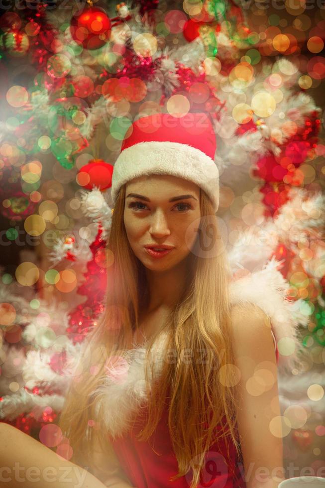 Funny christmas blonde girl in santa hat photo