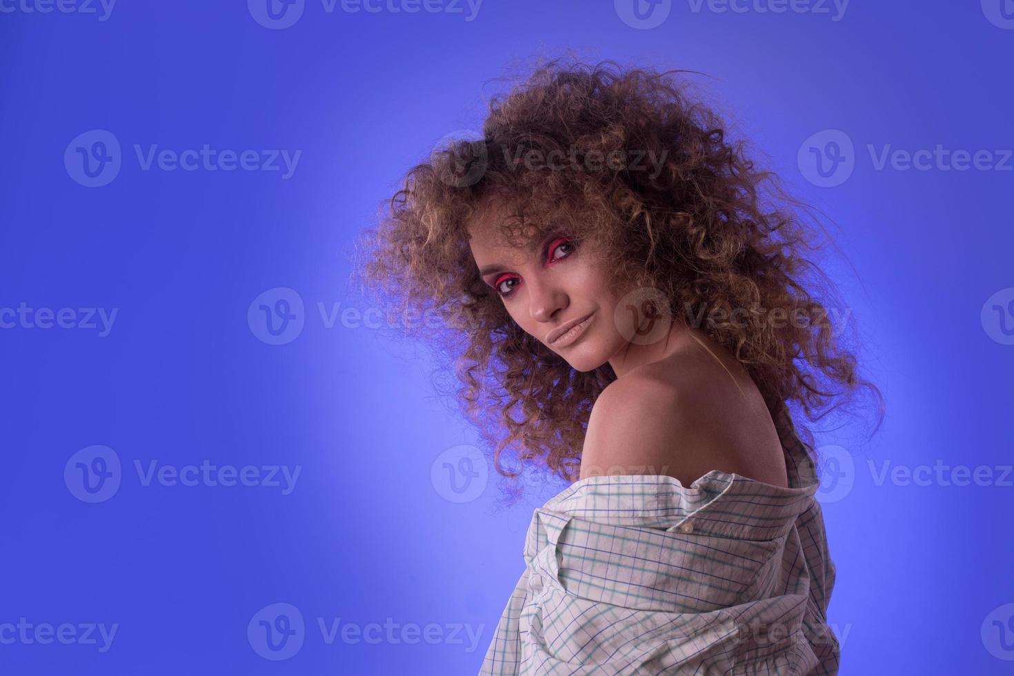 Beautiful young girl with afro hairstyle and colourful make up photo